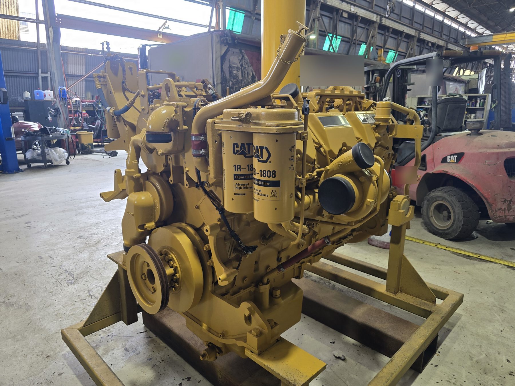CAT C27 rebuild showing new oil filters and turbocharger