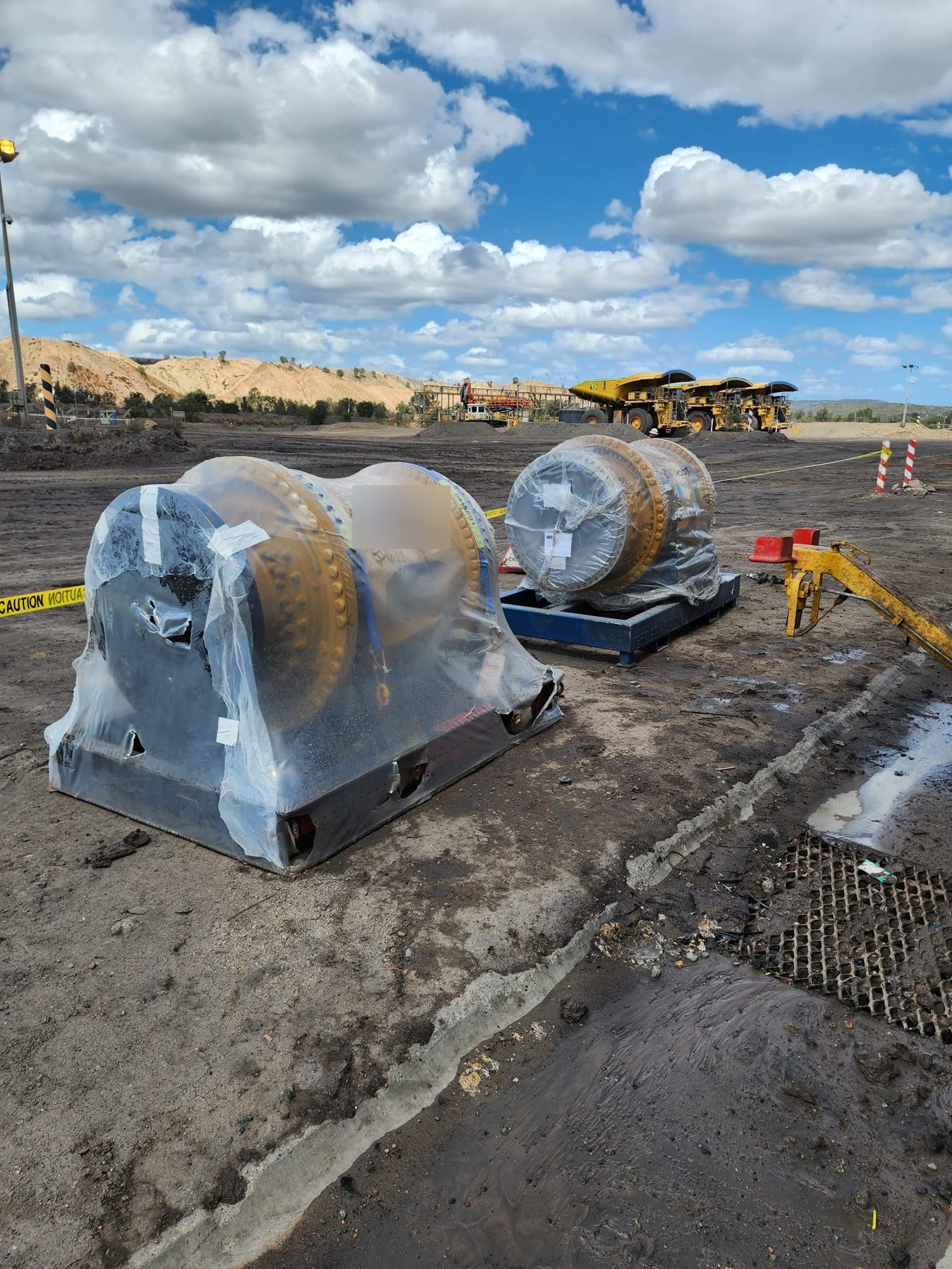 Final drive components wrapped and staged on site before a shutdown